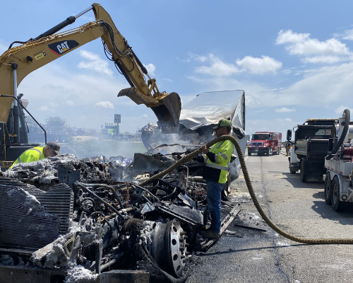 Burnt vehicle being worked on by Fuller's Towing.